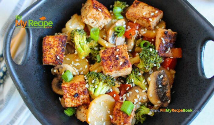 Easy Tofu Veggie Stir Fry Recipe idea with honey and sesame seeds. A no bake healthy vegan or vegetarian meal with udon noodles.