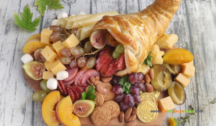 Best Charcuterie Board with Cornucopia recipe idea for Thanksgiving. Bake the easy puff pastry horn and add some fruits, various cheeses.