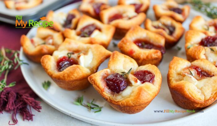 The most delicious mini Cranberry Brie Puff Pastry Bites appetizer recipe idea. Simple to make ahead for a sweet and savory holiday snack.