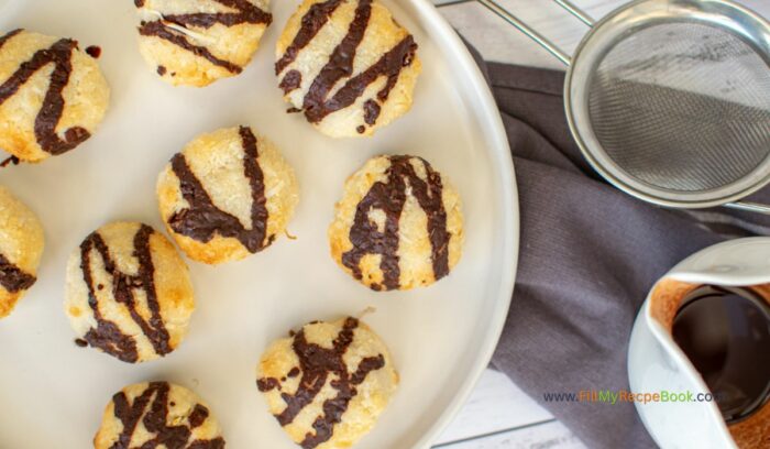 Bake these healthy Chocolate Drizzled Coconut Macaroons Recipe idea. With coconut oil and maple syrup added to the chocolate glaze.