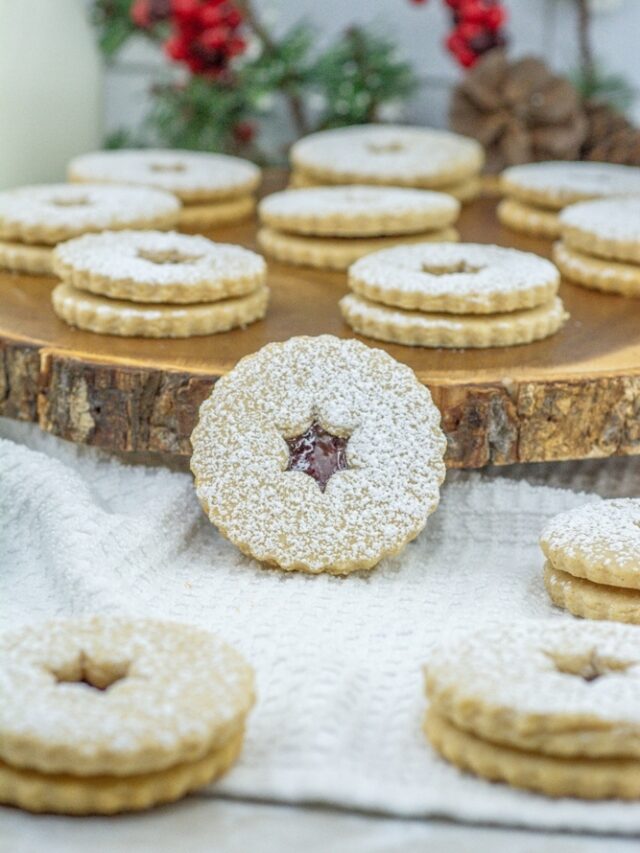 Homemade Linzer Raspberry Jam Cookies treats combine rich buttery goodness with a hint of almond, filled with raspberry jam for holidays.