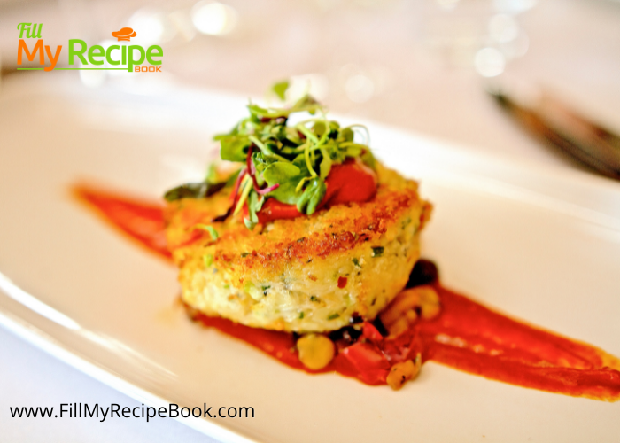 Crab Cake with Tomato Butter Sauce recipe plated for a gourmet fine dining dinner. Easy dish to serve for a meal set on corn salad.