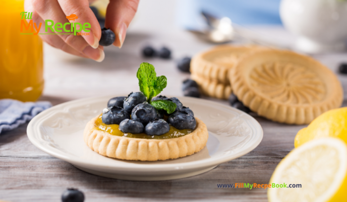 A mini Lemon Curd and Blueberry Tartlets Recipe. Oven baked dessert with shortbread crusts, filled with tangy lemon curd and blueberries.