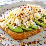 Nutritious Avocado Grated Egg on Toast recipe idea has a crispy bite with buttery avocado and grated boiled egg spiced with lemon pepper.