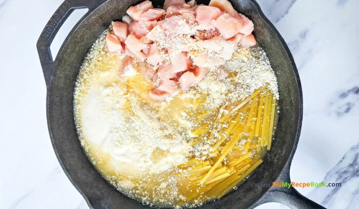 Adding the ingredients in an iron skillet, to bake in the oven.