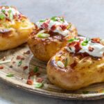 Loaded Baked Potatoes Grilled recipe. Easy homemade potato jackets filled with cream cheese and bacon bits topped with cheddar for a meal.