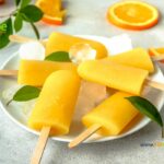 Simple Homemade Orange Popsicles recipe. A Summer time snack with fresh orange juice, frozen ice cream for kids and adults to enjoy.