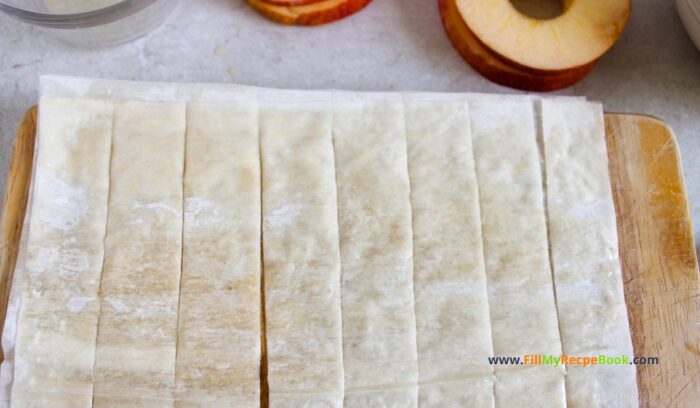   Using a pizza cutter or a knife, cut the sheet lengthwise Apple Strudel Slices Recipe to have for a sweet dessert. Simple homemade from scratch idea with wrapped phyllo dough on apple rounds, snack.