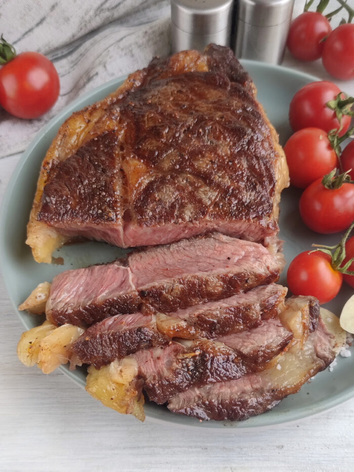 Best Grilled Ribeye Steak recipe in a cast iron pan. Easy stove top idea for dinner or lunch as the steak is grilled with butter, garlic.