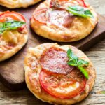 Fresh Mini Pizza Appetizer recipe idea. Easy healthy two ingredient pizza base with pepperoni and cheese for snacks on platters.