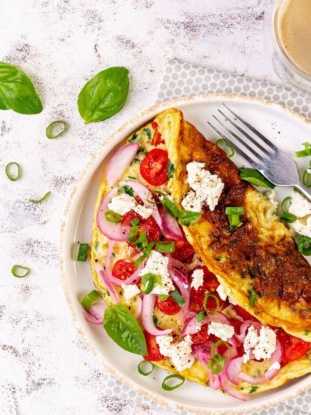 Tomato Feta Cheese Omelette Idea for breakfast. Easy homemade recipe with salad of cherry tomato, goat feta cheese and onion meal.