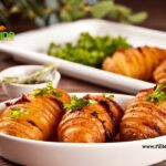 An easy oven Baked Hasselback Potato with Bacon and butter recipe. Delicious potato side dish with herbs for lunch or dinner meals.