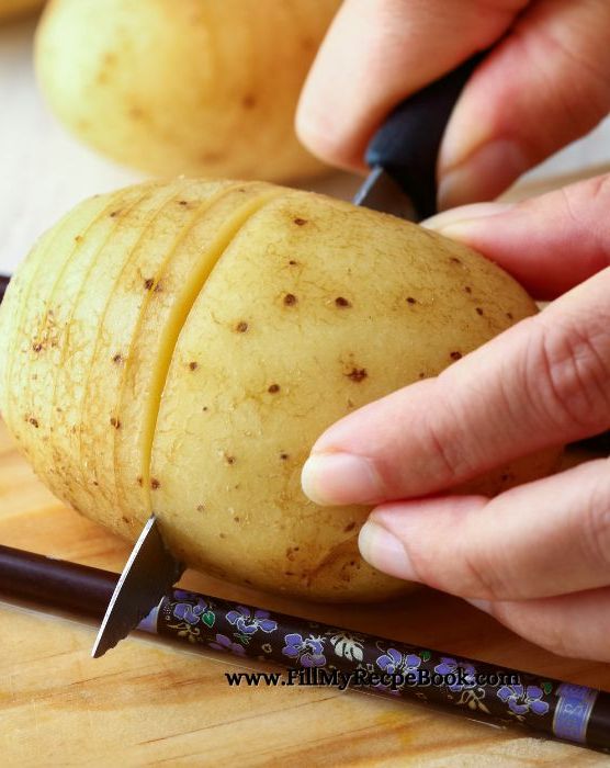 slicing hasselback potatoes to fill and bake. An easy oven Baked Hasselback Potato with Bacon and butter recipe. Delicious potato side dish with herbs for lunch or dinner meals. 