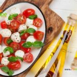 Cherry Tomato Caprese Salad with glazed balsamic vinegar recipe. Easy tasty side dish with mozzarella balls, fresh basil leaves and spices.