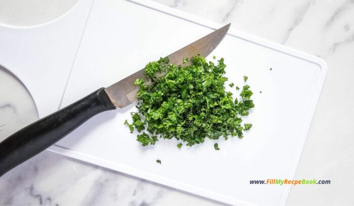 chopping parsley and nuts and all the ingredients, Mini Appetizer Cheeseballs Bites recipe for a No Bake party snack. Easy individual cheeseballs with bacon, pecan nuts, with a pretzel stick.