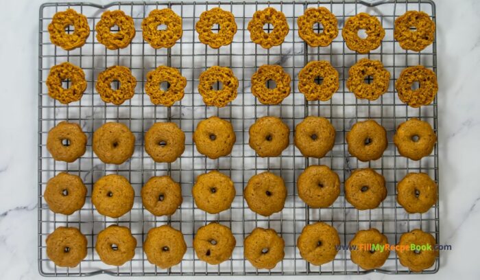 cutting in half, These Mini Pumpkin Bundt Cakes recipe are spicy and made from scratch. An easy bake,  with vanilla butter icing, makes a moist dessert.