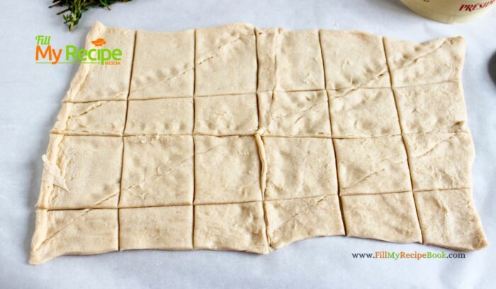 cutting the puff pastry dough in squares for, The most delicious mini Cranberry Brie Puff Pastry Bites appetizer recipe idea. Simple to make ahead for a sweet and savory holiday snack.