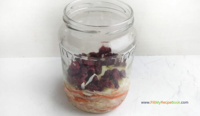 filling up the jar in layers for, Easy Homemade Healthy Sauerkraut Recipe. Best idea for fermenting vegetables provides health benefits through probiotics that boost digestion.