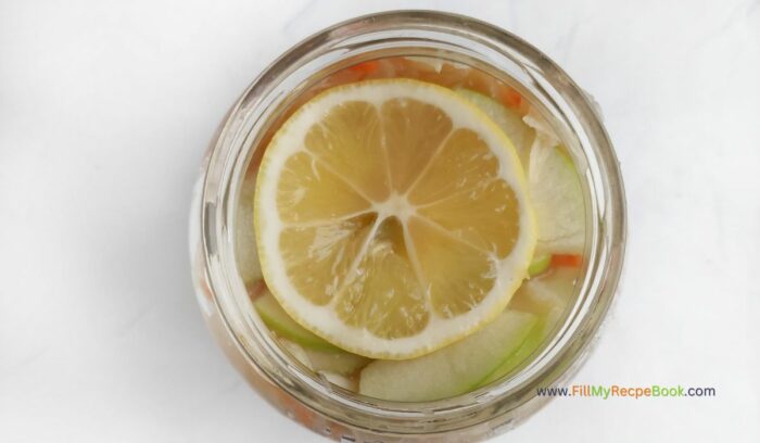 adding a lemon on top of the sauerkraut, for final topping for, Easy Homemade Healthy Sauerkraut Recipe. Best idea for fermenting vegetables provides health benefits through probiotics that boost digestion.