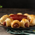 Create these easy Homemade Pigs in a Blanket for appetizers, served warm or cold. These delightful mini puff pastry snacks filled with small sausages are perfect for any party.