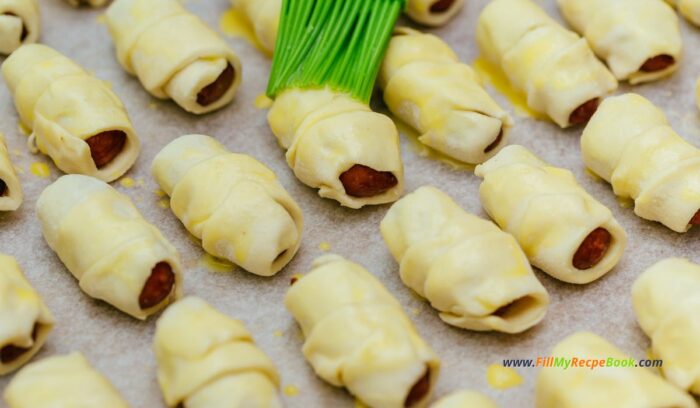 brush the rolled mini puff pastry with egg wash before you bake and drizzle some salt on for that extra taste. mini puff pastry pigs in a blanket snack or appetizer for the festive season, platters