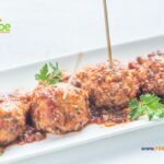 Bake these delicious turkey meatball skewers recipe for toothpick appetizers or snacks at parties. Garnished with cranberry sauce.