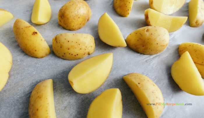 raw potato cut into wedges for roasting with parmesan. An oven Roasted Parmesan Potato Butternut and Chicken recipe for a meal. Delicious all in one pan, half a chicken and vegetables for lunch.