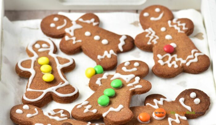 Festive and Easy Gingerbread Men Cookies Recipe Idea for a Delightful Snack. These cookies feature a soft center, crispy edges, and a spicy flavor, all beautifully decorated with a white glaze and mini M&M’s.