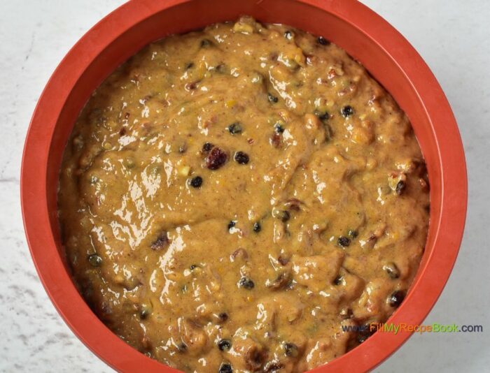 added the mixed batter into a baking pan for baking. Festive Cranberry Christmas Fruit cake recipe with pecan nuts a glaze of orange juice. Moist and alcohol free, simple bake for the holidays.