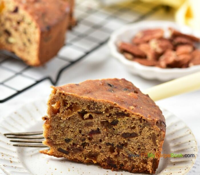 a light and flavorful Festive Cranberry Christmas Fruit cake recipe with pecan nuts a glaze of orange juice. Moist and alcohol free, simple bake for the holidays.