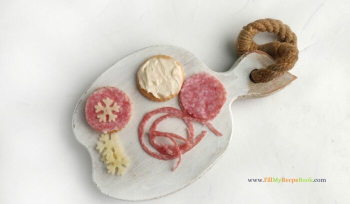 salami and cheese snowflakes on crackers for appetizers for Christmas snacks during the festive holidays