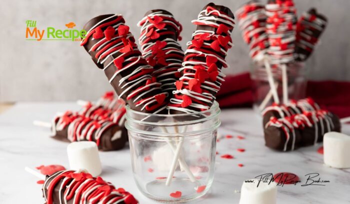 Simple Marshmallow Pops for Valentine's idea for kids. Stack three marshmallows on a stick, dip in chocolate, and add heart sprinkles.