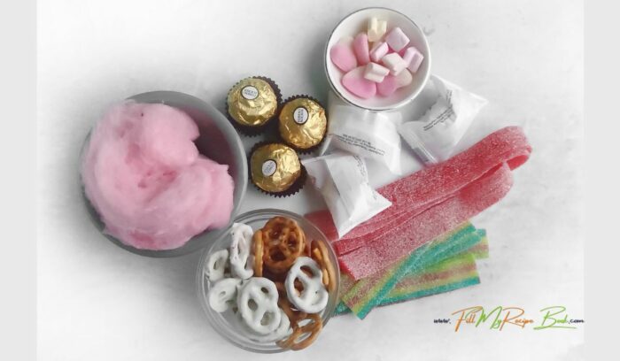 Pretty ingredients of candy pretzels, chocolates, marshmallows to design a valentines day DIY Bouquet for anyone as a gift.