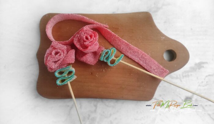 Making the lush red rose and green leaves on a skewer for this, Learn how to make a Valentine's Day DIY Candy Bouquet idea to create for a special someone. A beautiful packaged gift to suit anyone.