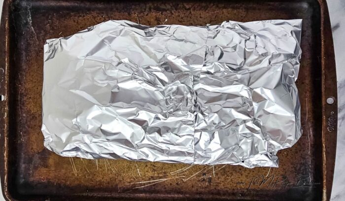 Wrap the bread in the foil (keeping it on the baking sheet), and bake for 15 minutes.