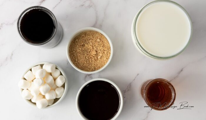 Ingredients for a Cozy S’mores Latte Recipe. coffee or espresso, chocolate syrup, s;'mores syrup, cracker crumbs, mini marshmallows, milk