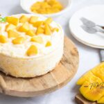 Easy Mango Cheesecake Dessert recipe to make with cream cheese and lemon and biscuit base. No Bake creamy filling with mango slices.