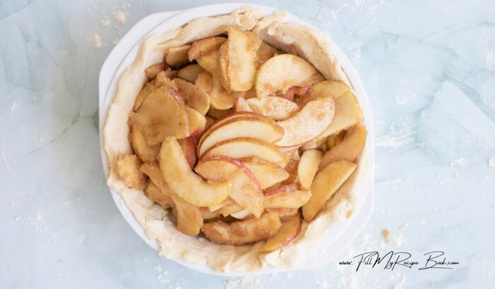 Pour the apple filling into the prepared bottom crust, mounding it slightly in the center.