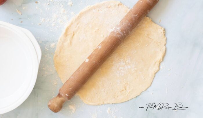 Roll out the second portion of chilled dough on a lightly floured surface into a circle slightly larger than the pie dish.