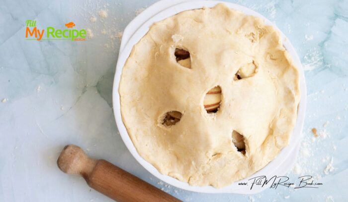 Carefully place the rolled-out dough over the filling. Trim any excess dough hanging over the edges, leaving about a 1-inch overhang. Fold the overhang of the top crust under the edge of the bottom crust, then crimp the edges using your fingers or a fork to seal the pie.
Use a sharp knife to create several small slits or decorative vents in the top crust to allow steam to escape during baking