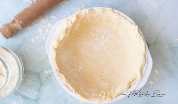 Transfer the rolled-out dough to the pie dish, pressing it gently against the bottom and sides.