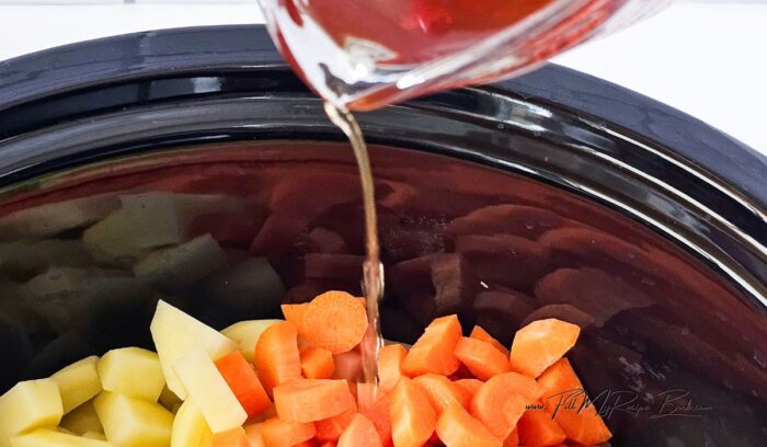 Place the vegetables in the slow cooker and pour over the stock.