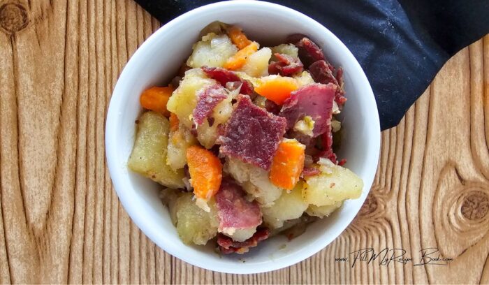 Mix the corned beef hash with the vegetables, and serve.