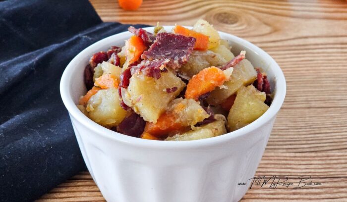 Homemade easy corned beef hash recipe with vegetables cooked in a slow cooker, then fry the corned beef and add it to the dish for for a meal.