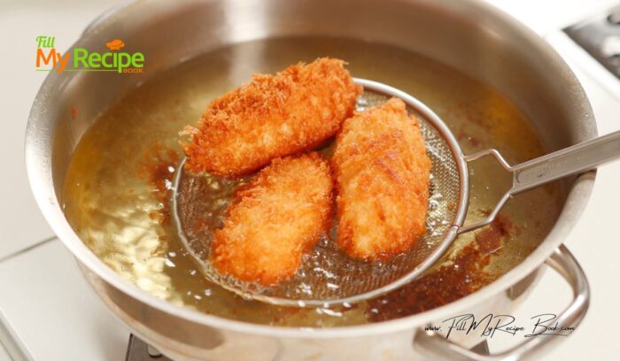 taking out the fried vetkoek to drain, for Quick No Yeast Vetkoek Recipe idea. Crispy South African mouth watering vetkoek made with baking powder fried in hot oil for a meal.