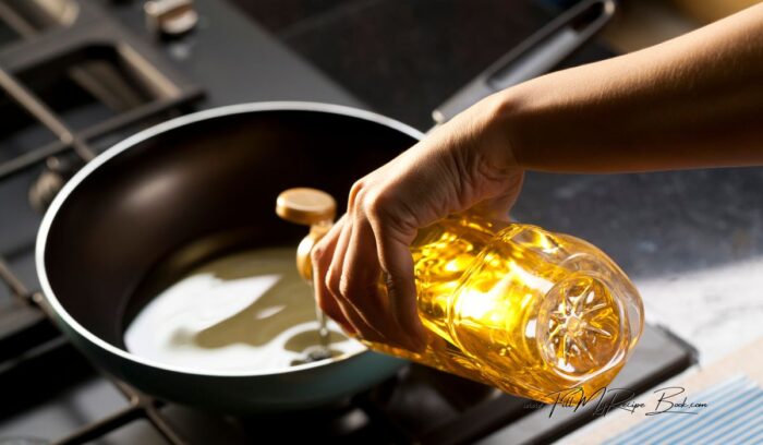 placing oil in a pan or pot to bring to boil. enough oil so the dough ball for vetkoek can float and turn over by itself once it is cooked.