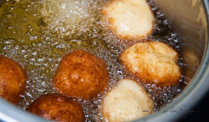 frying the vetkoek made with baking powder in hot oil. Quick No Yeast Vetkoek Recipe idea. Crispy South African mouth watering vetkoek made with baking powder fried in hot oil for a meal.