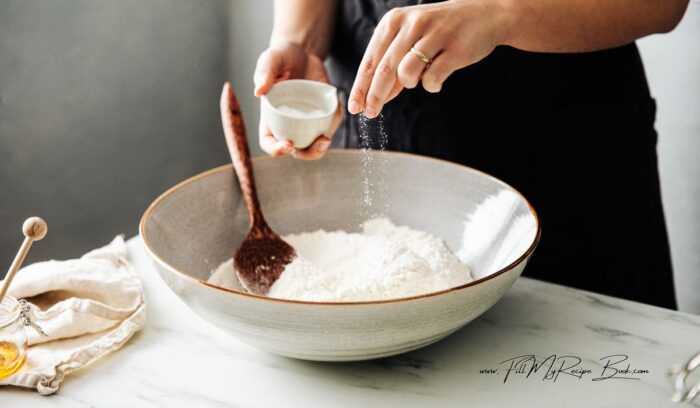 mixing dry ingredients for the start of a yeast free vetkoek recipe. Quick No Yeast Vetkoek Recipe idea. Crispy South African mouth watering vetkoek made with baking powder fried in hot oil for a meal.