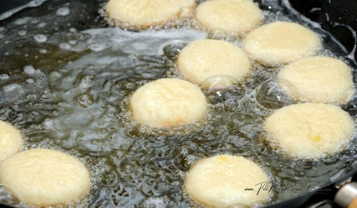 frying the vetkoek in boiling oil. notice they are in oil that they can turn around in when cooked on one side. 3 ingredient vetkoek easy recipe.