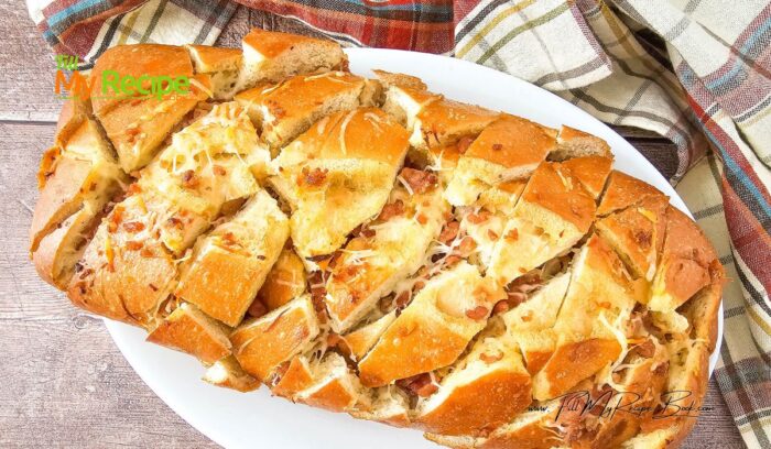 Savory Bacon Cheese Pull Apart Bread recipe. Simple appetizer or starter to bake with a ready made loaf of bread, using garlic and butter.